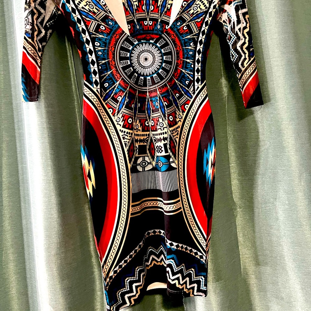 Tribal print body on dress . Crew line in front and scoop back .Very flattering.